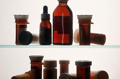Indistinguishable Medcine bottles on medicine cabinet shelves