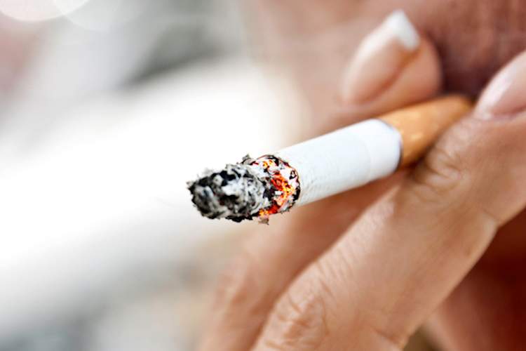 Adult woman smoking cigarette.