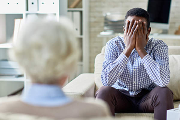 Man crying in therapy.