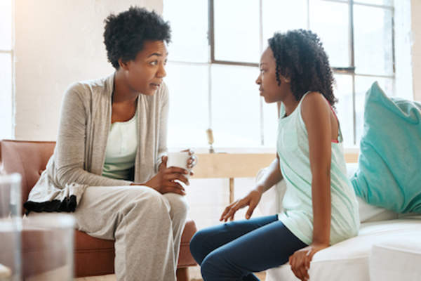 Mother having talk with daughter.
