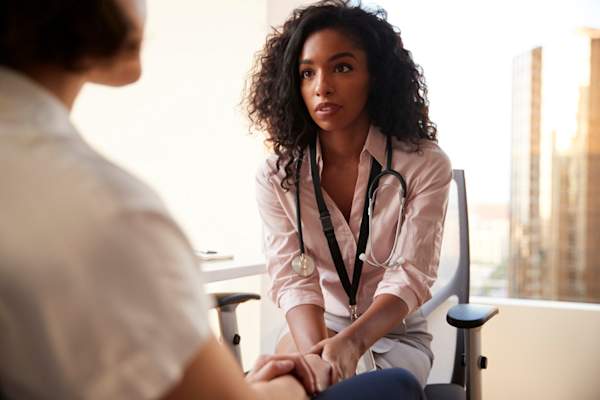 doctor talking to patient, serious looking