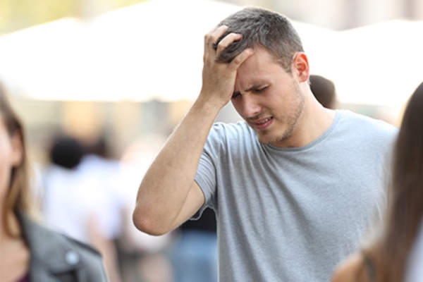 Man getting dizzy while walking on the street.