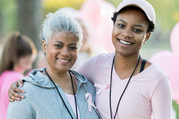 Smiling mother and daughter breast cancer support and awareness.