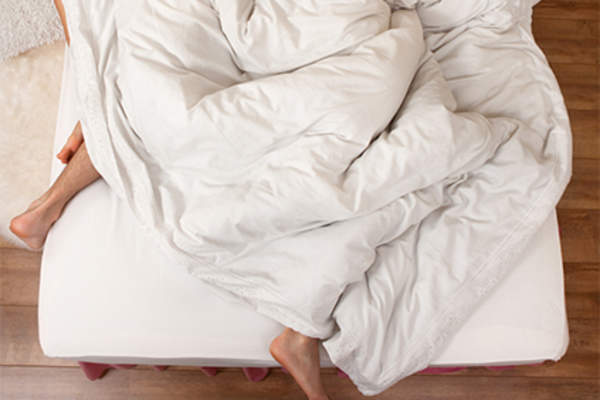 Couple tossing and turning in bed.