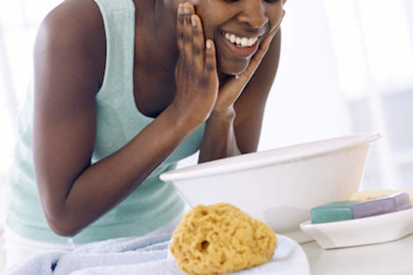 Washing face in basin.