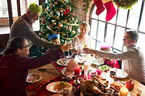 Family eating a Christmas dinner.