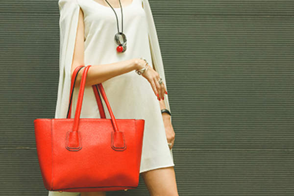 Woman with a leather tote handbag.