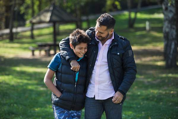 Father and son talking on walk.