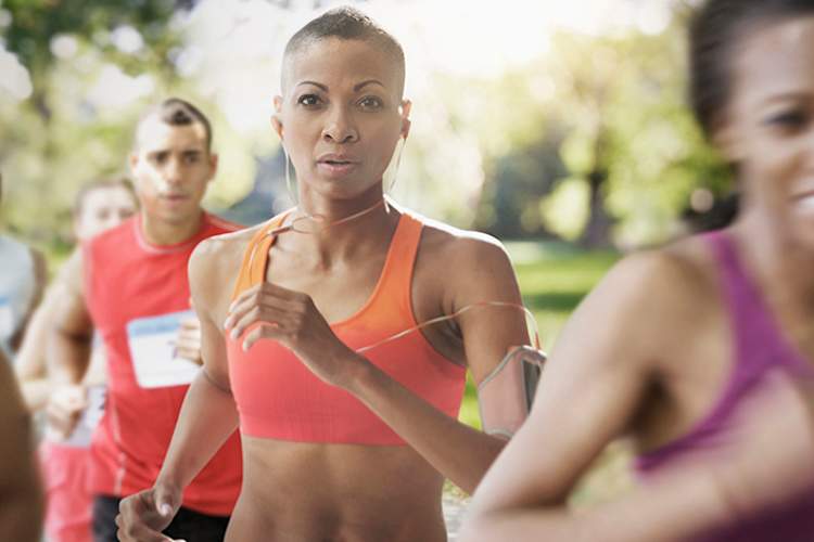 Middle age woman running in a marathon.
