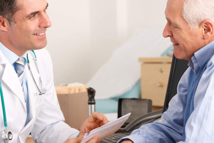 Man talking to gastroenterologist.