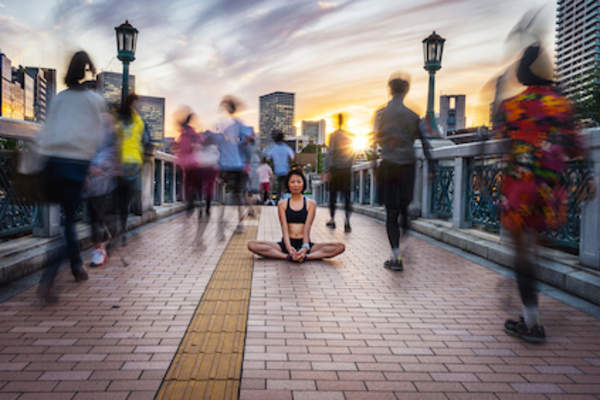 Mindfulness concept, meditating on busy street.