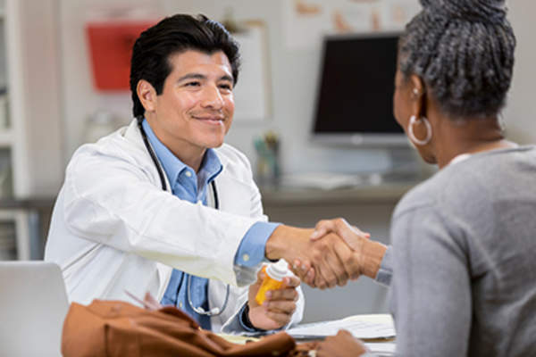 Doctor and patient shaking hands.