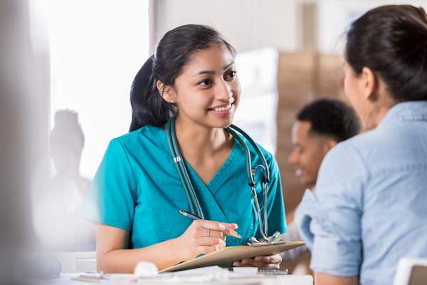 Nurse talking to patient at screening event.