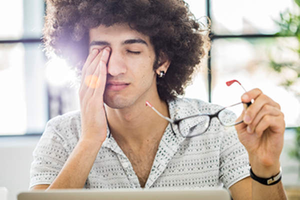 Man rubbing his eye.