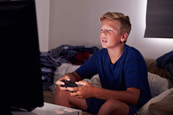 Teenage boy playing video games.