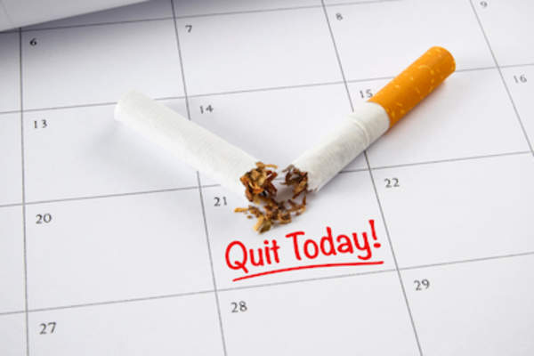 Broken cigarette on calendar, marked quit today.