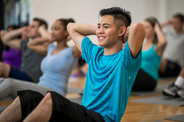 Man doing sit-ups in an exercise class