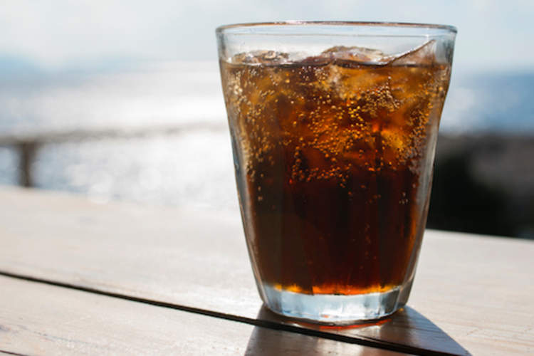 A glass of diet soda on a table.
