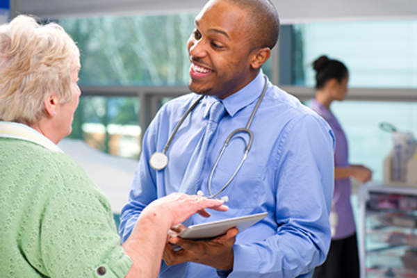 Smiling doctor and female patient.
