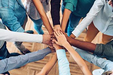 Many hands of different skin colors.