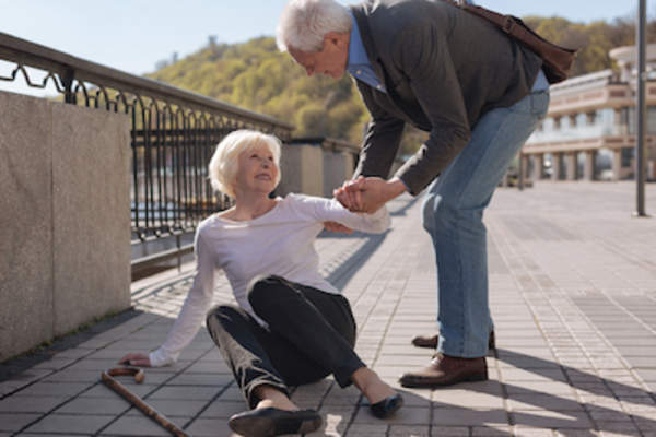 Man helping up woman after a fall