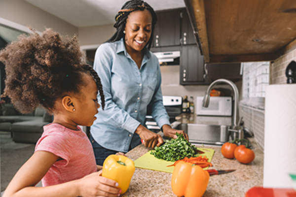 Mother and daughter cooking together.