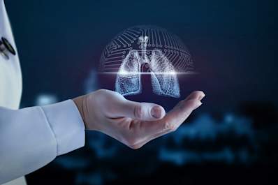 Doctors hand holding digital lungs, lung cancer concept.