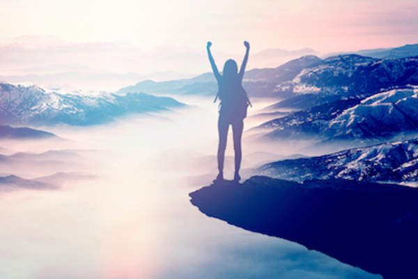 Inspirational photo, woman's arms raised in victory.