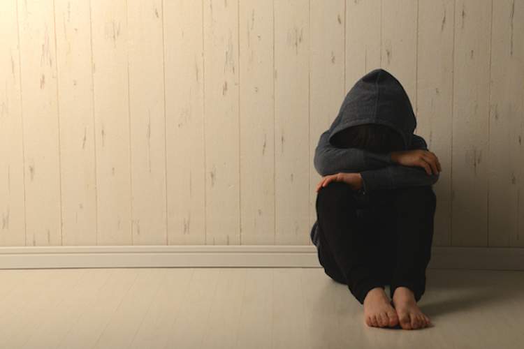 Depression, youth in room alone.