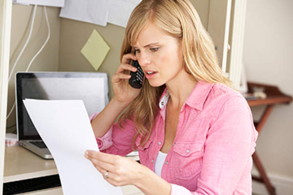 Frustrated woman making a complaint on the phone.