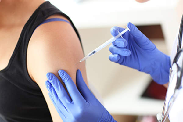 Woman getting a vaccination.