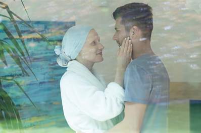Couple in intimate embrace after cancer.