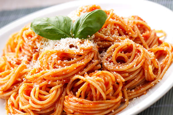 Spaghetti with tomato sauce on a white plate