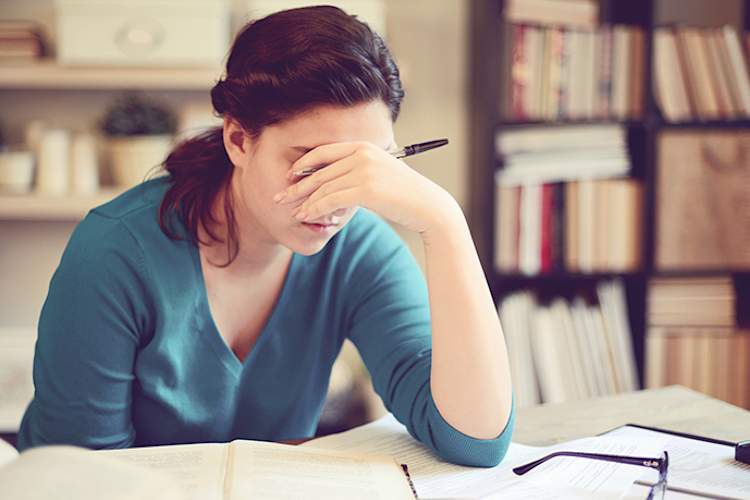 Depressed student doing schoolwork.