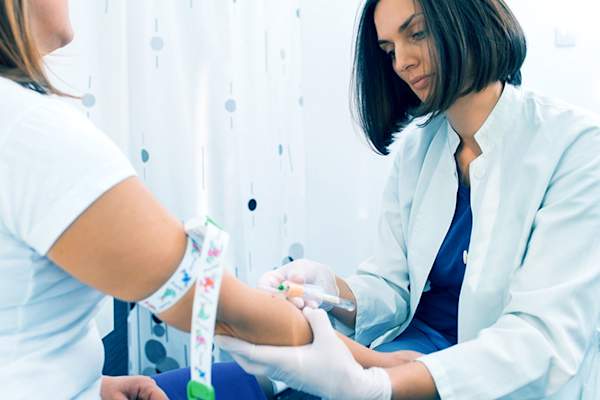 Nurse performing blood test.