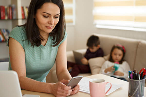 Mother looking at her smartphone.