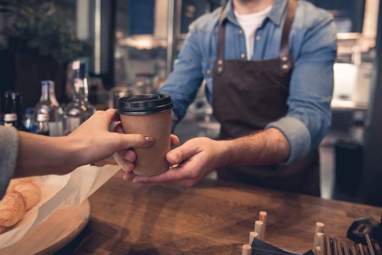 Woman buying a coffee.