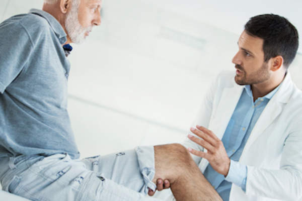Man in doctors office, getting check up.