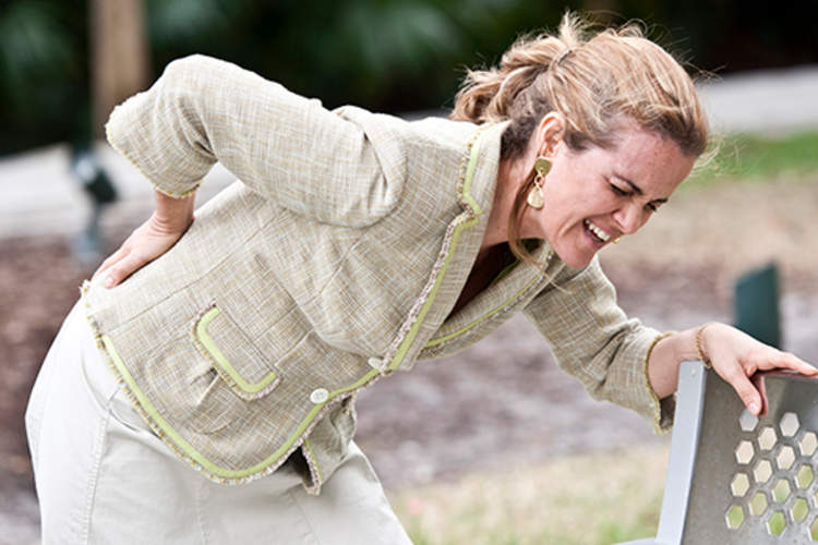 Woman bending over in pain