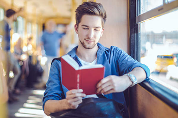 Man reading on public transportation.