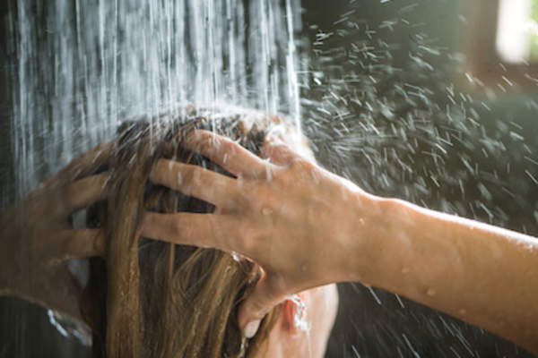 woman washing hair in shower.