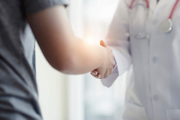 Doctor and patient shaking hands.