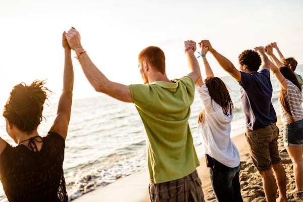 Support group gathering on beach.