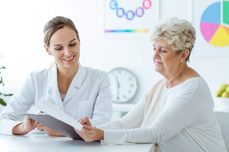 Overweight senior woman with nutritionist.
