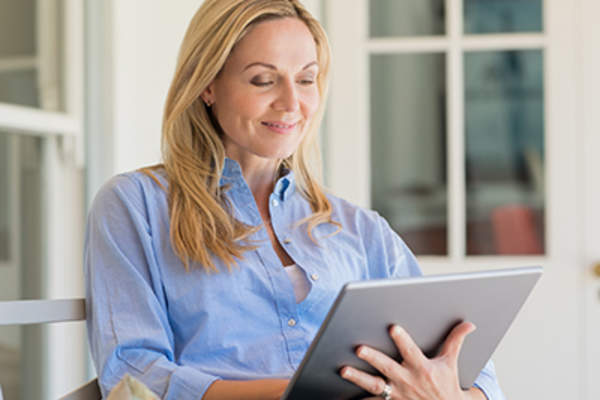 Woman reading on a tablet.