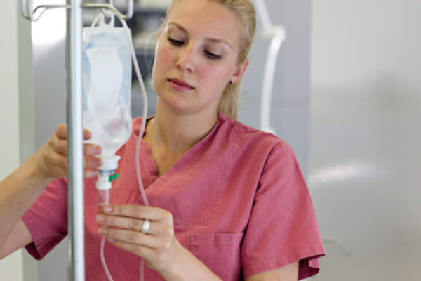 A nurse preparing an infusion.