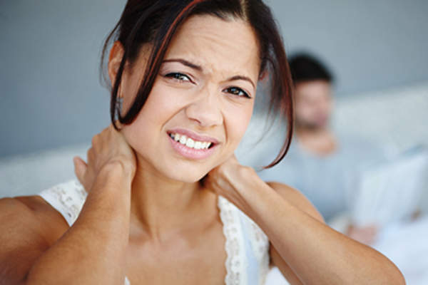 Woman with morning stiffness in her neck.