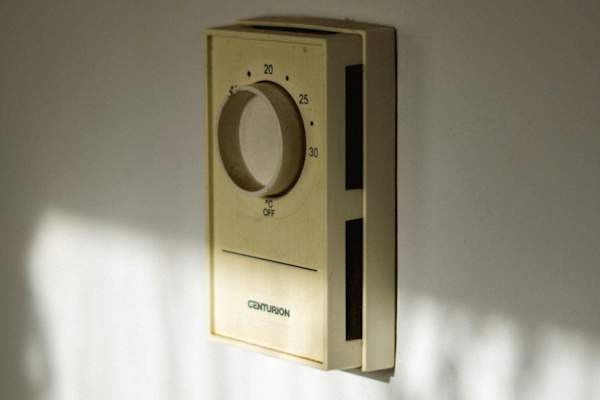 old thermostat on wall