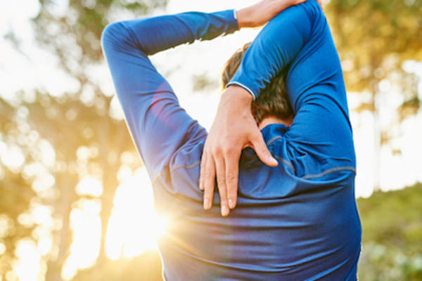 Man stretching shoulder.