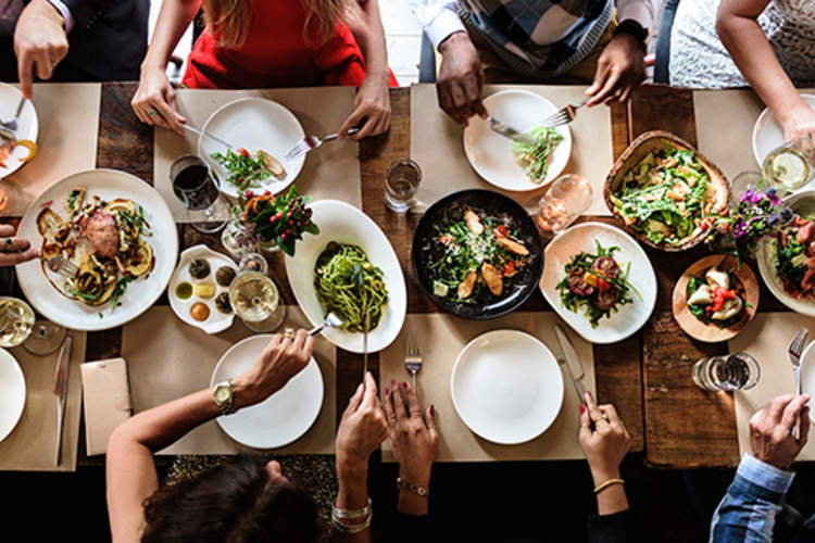 Group of people serving a big meal.